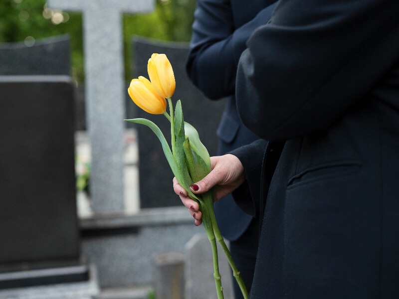 Tulips being brought to a grave at the cemetery